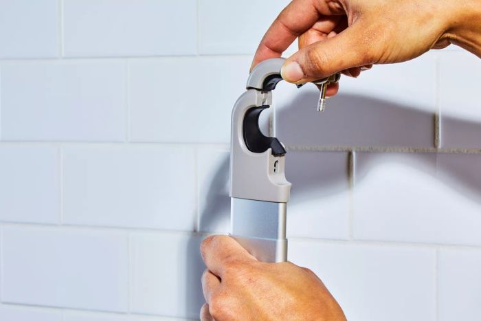 A person setting up the simplehuman Shower Caddy