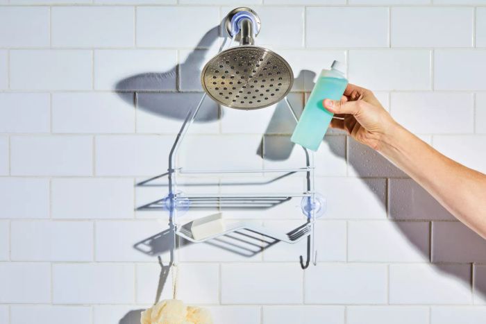 Someone placing body wash onto the Zenna Home Shower Caddy