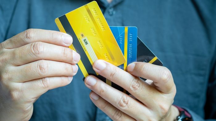 Person holding a variety of credit cards