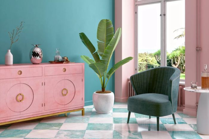 A vibrant tropical living room adorned with millennial pink and teal accents.