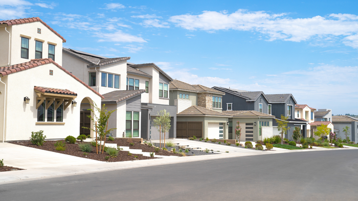 A row of homes in a bright, sunny neighborhood.