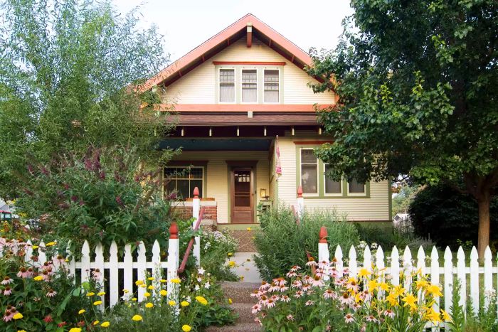 A charming house with a white picket fence at the front