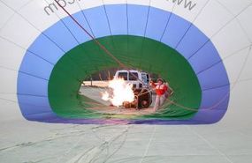 The burner flame blasts hot air into the balloon.