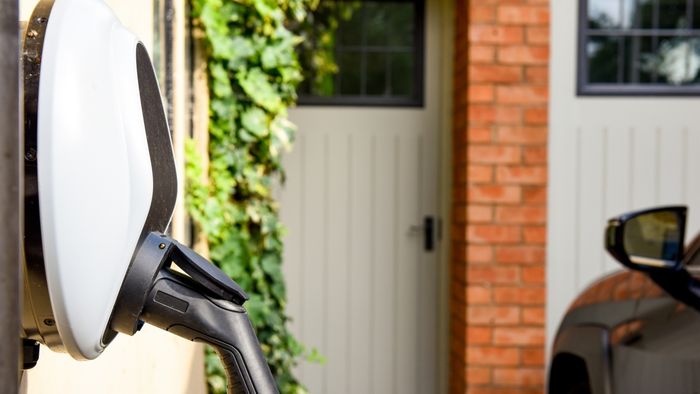 An electric vehicle charging at a residential home
