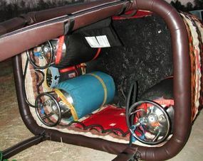 A hot air balloon basket equipped with three propane tanks.
