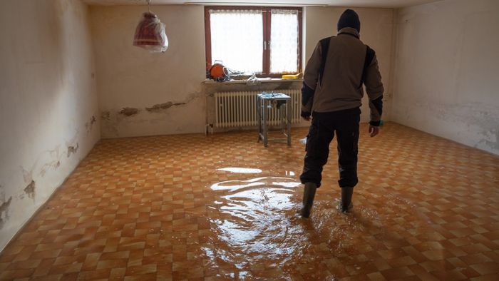 Person walking through a flooded basement