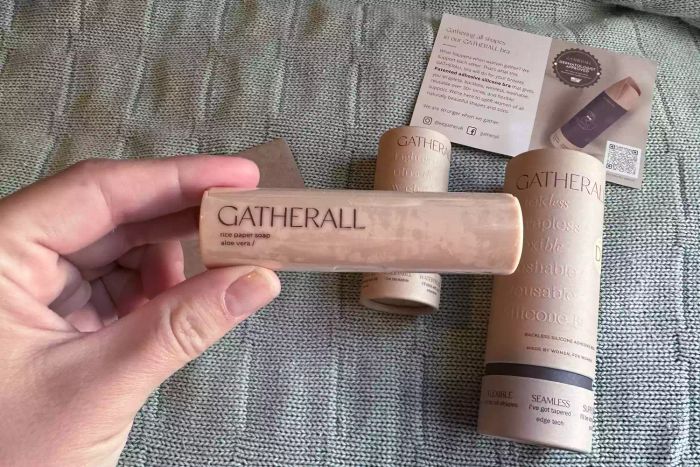 A hand holding a tube of Gatherall Aloe Vera Rice Paper Soap