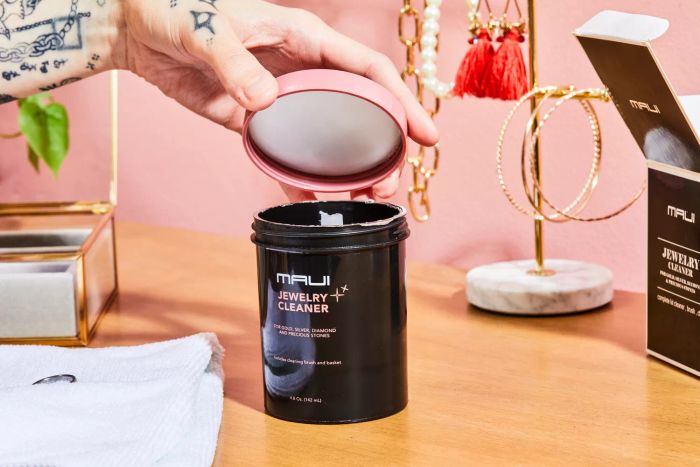 An individual opening the Maui Jewelry Cleaner Kit