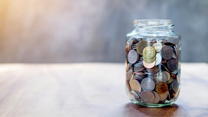 container brimming with assorted coins