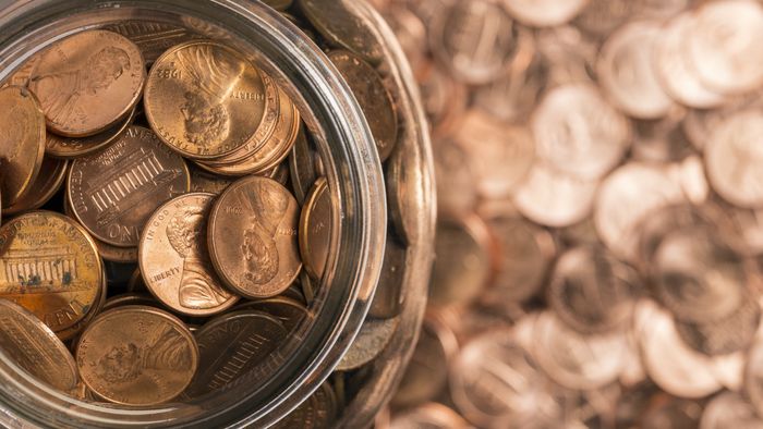 Pennies in a jar, with the background blurred