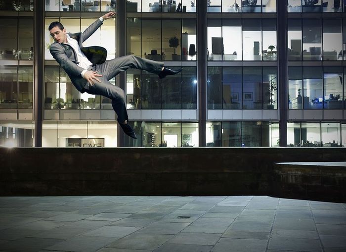 A person floating above a city, with a vast urban landscape beneath them.