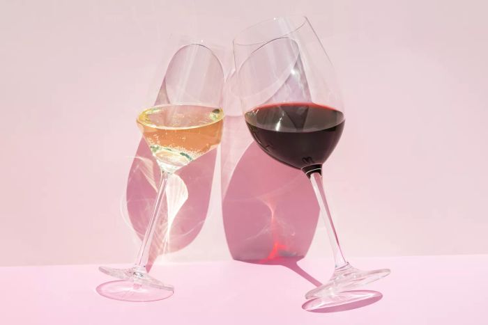 wine glasses placed on a pink backdrop