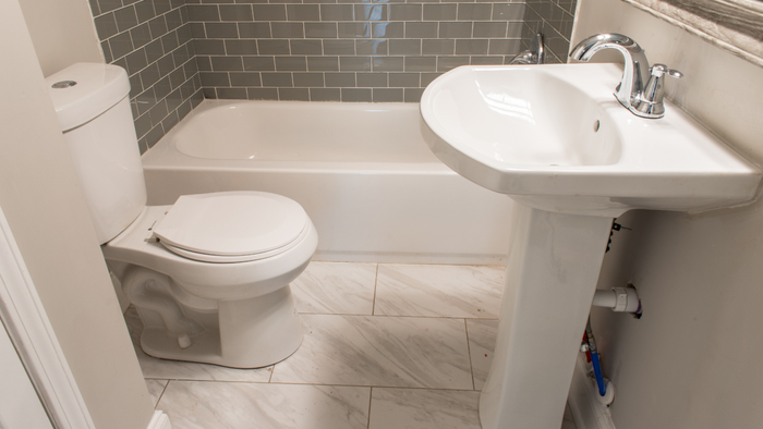 a small bathroom styled with neutral shades