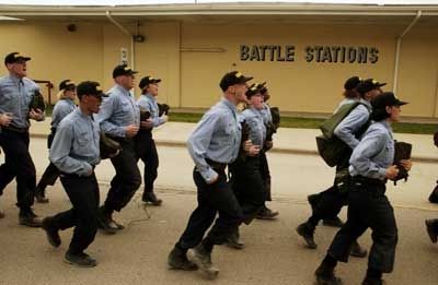 Navy personnel are practicing drills as part of their training regimen.