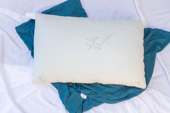 Snuggle-Pedic Adjustable Shredded Memory Foam Pillow showcased on blue pillowcases