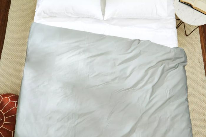 The Slumber Cloud Essential Duvet Cover elegantly draped over a bed, complemented by matching pillows