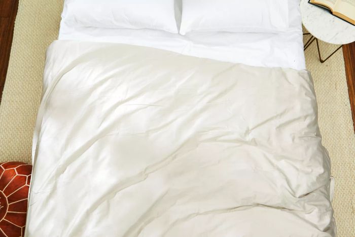 The Parachute Sateen Duvet Cover elegantly displayed on a bed