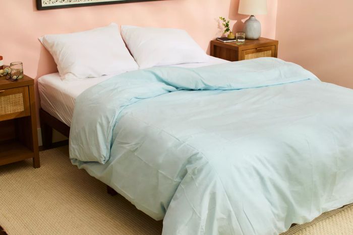 The Riley Percale Duvet Cover displayed on a bed in a bedroom
