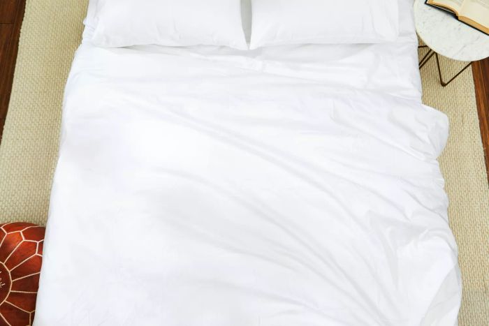 The Boll & Branch Signature Hemmed Duvet Set elegantly showcased on a bed