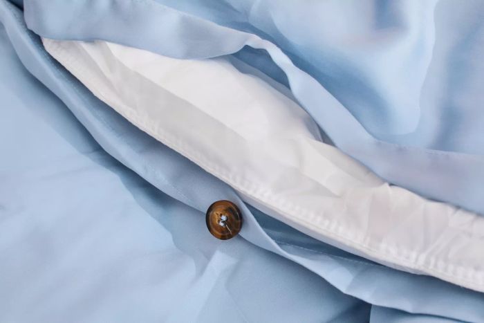 Close-up of the button closure on the Sijo AiryWeight Eucalyptus Duvet Cover.