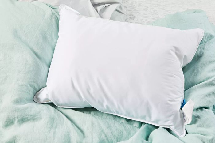 Slumber Cloud Core Down Alternative Pillow showcased on a green blanket