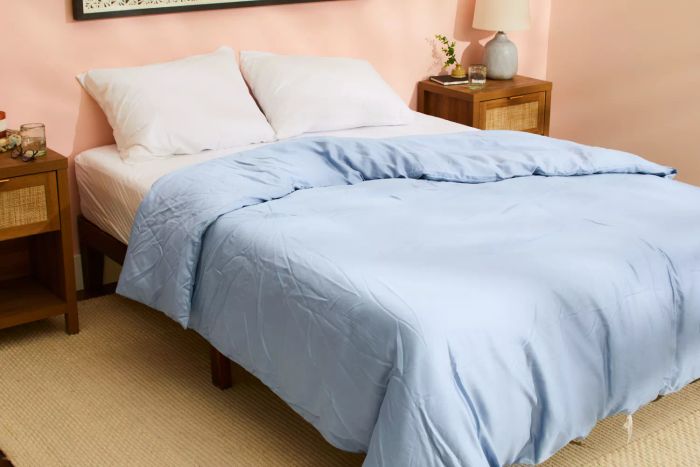 The Sijo AiryWeight Eucalyptus Duvet Cover elegantly displayed on a bed in a bedroom setting