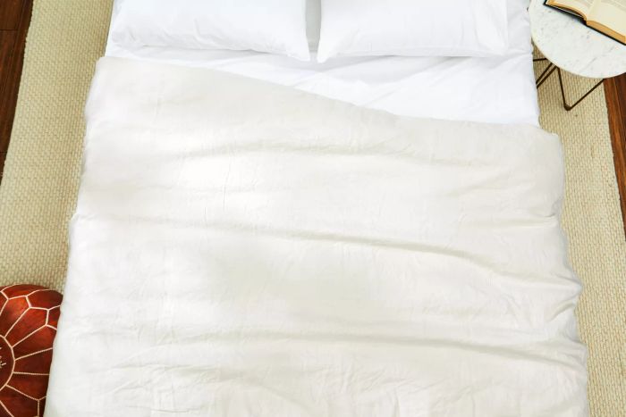 Quince European Linen Duvet Cover showcased with pillows on a bed