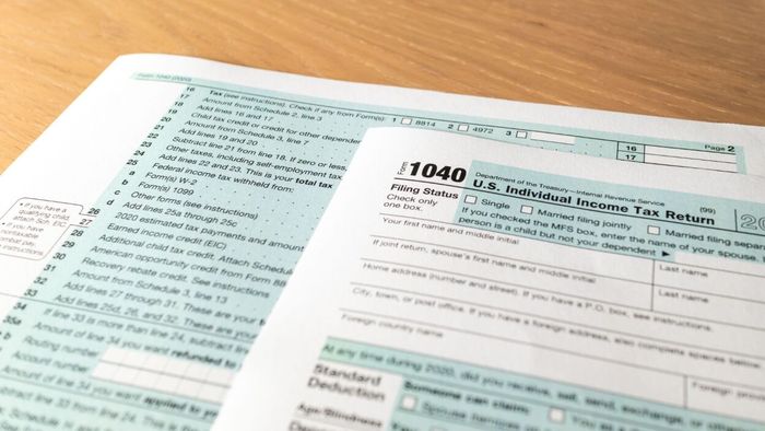 A US 1040 tax form placed on a surface