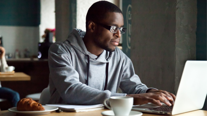 Young professional working intently on a laptop.