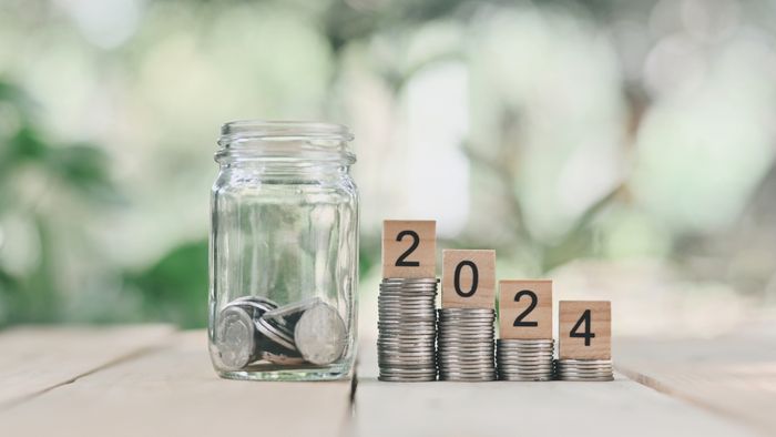 coins in a jar with '2024' written in block letters