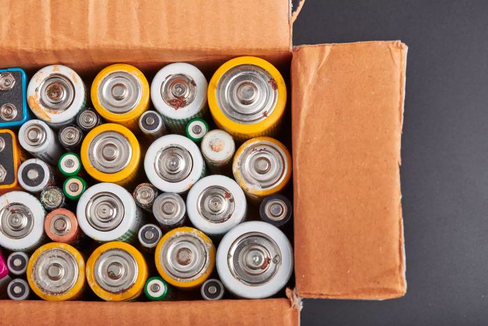 Used batteries stored in cardboard boxes for collection and recycling.