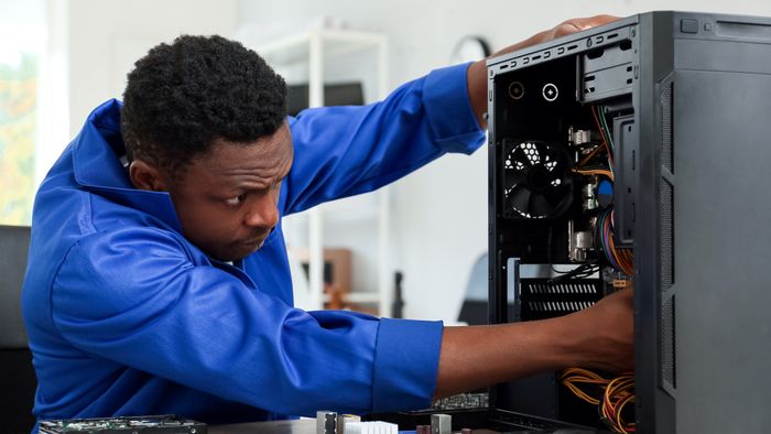 A person dismantling a computer