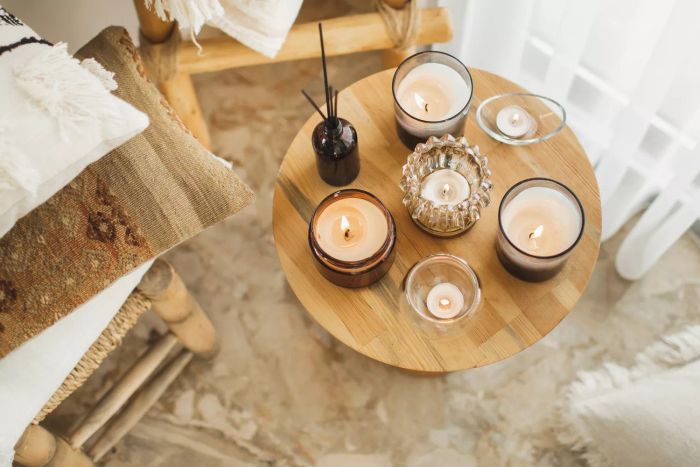 Boho-inspired interiors featuring wicker furniture made from sustainable materials, handcrafted cushions, aromatic reed diffusers, lit candles, and soft textiles. A perfect blend of hygge and aromatherapy, ideal for cozy autumn or winter days.