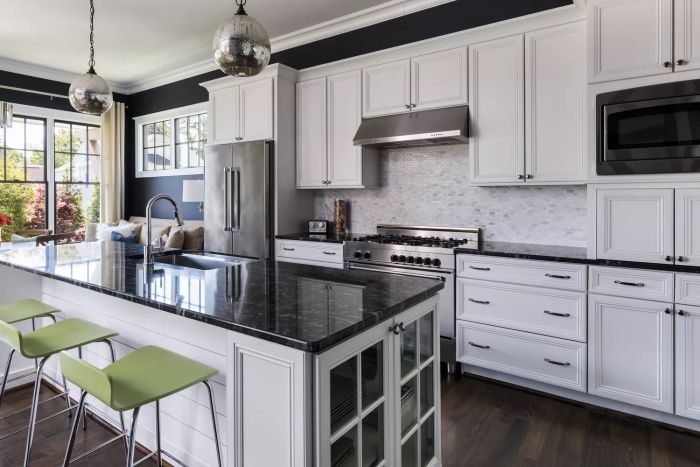A sleek, contemporary kitchen featuring a glimpse of the adjacent seating area