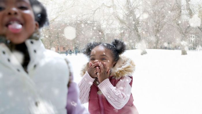 Girls playing joyfully in the snow.