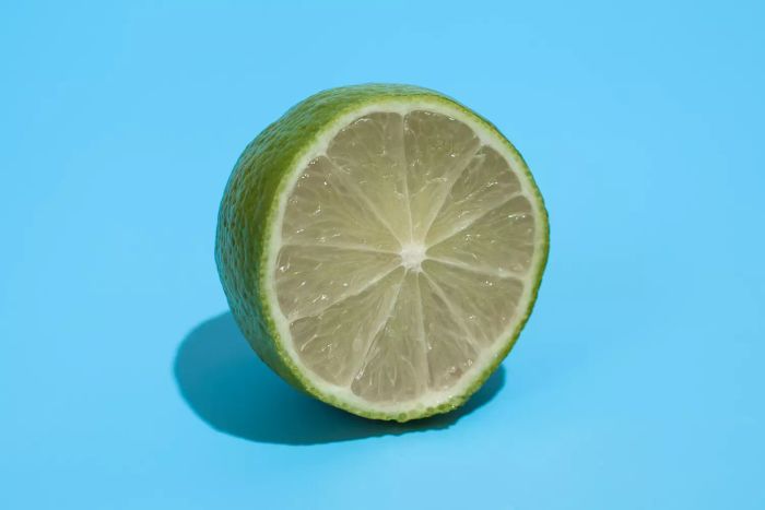 A fresh, succulent lime on a vibrant blue backdrop.