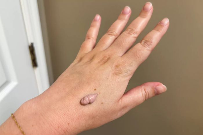 A drop of Kinfield Sunglow SPF 35 on the back of a hand