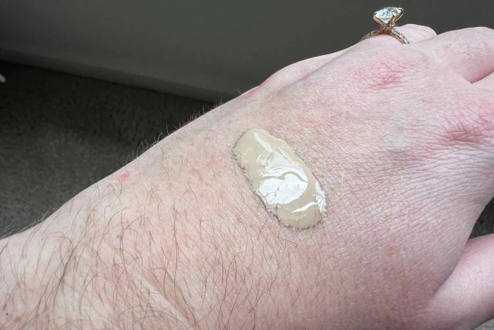 A drop of SkinCeuticals Physical Fusion UV Defense SPF 50 on the back of a hand