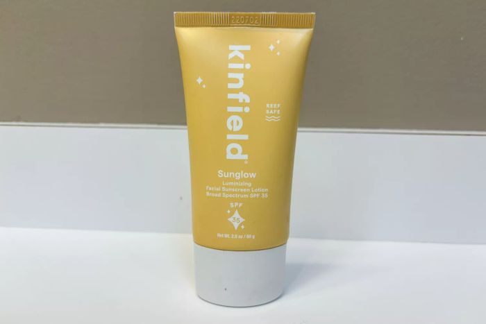 A tube of Kinfield Sunglow SPF 35 placed on a counter
