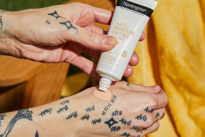 Neutrogena Purescreen+ Mineral UV Tint Face Liquid Sunscreen being applied to the back of a hand