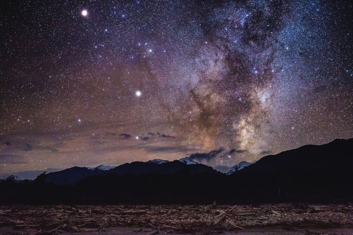 The Milky Way stretches above the Southern Alps of New Zealand, visible from Bruce Bay on the West Coast.