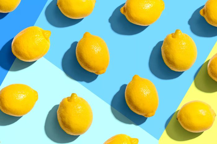 A collection of lemons set against a blue backdrop
