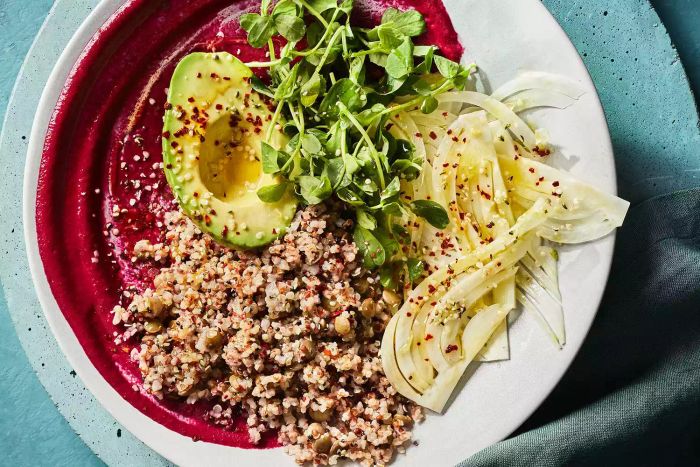 A bowl of mixed grains served with beets and fennel