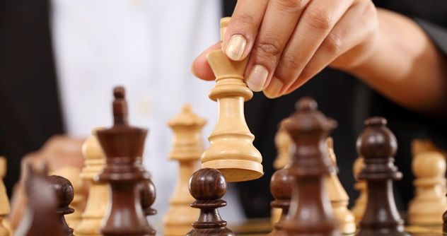 A businesswoman playing chess