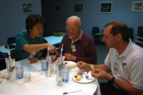 Astronauts taste test different space foods.
