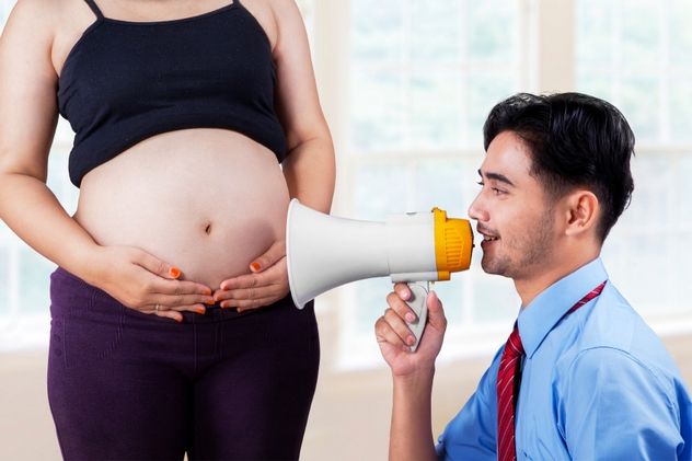 Husband talking to his baby