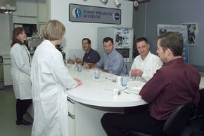 Dietitians brief the STS-113 crew members during a food tasting session to assess and refine space meal options.