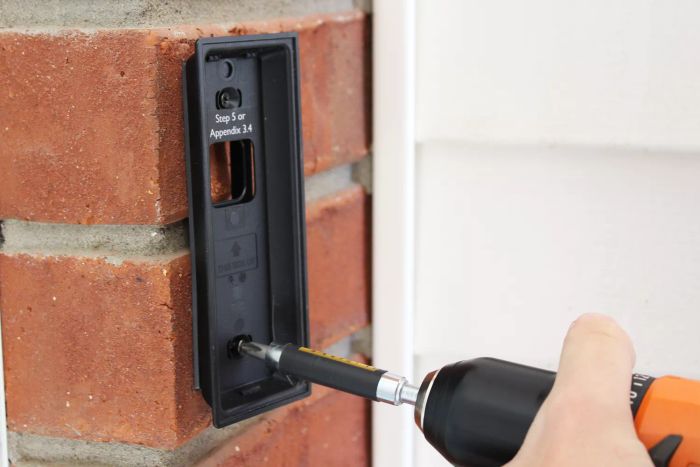 A person setting up an Eufy Battery-Powered Video Doorbell 2K