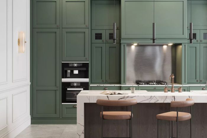 A modern kitchen with a green wall, showcasing an elegant interior complete with high stools at the kitchen counter.