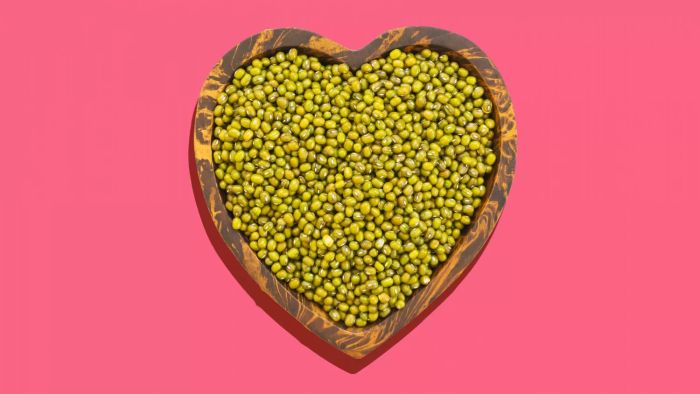 A Top-Down View of Mung Beans in a Heart-Shaped Bowl Against a White Backdrop
